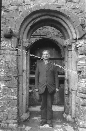 HOLYCROSS ABBEY CARETAKER MR PHILIP MC GRATH IN OLD ROMANESQUE DOORWAY LEADING FROM S. AISLE TO CLOISTERS